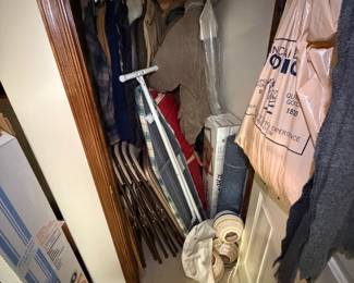 folding chairs, ironing board, clothes,
