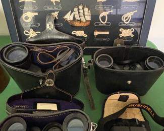 Vintage binoculars with their original leather cases and nautical knot display