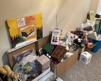 Packed room with boxes, games, and household supplies.