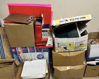 Boxes of office supplies, stationery, and paper goods.