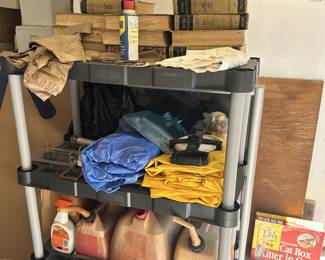 Utility shelving with clothing, linens, and supplies.
