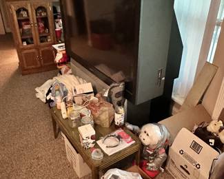 Packed room with furniture, toys, and decor.