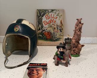 Football helmet, children's book, figurines, and decor.