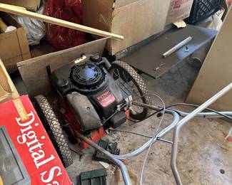 Small gasoline engine, lawn equipment, hoses, and shop tools.
