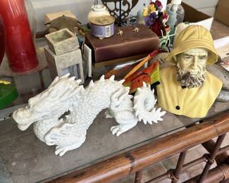 White dragon figurine, fisherman bust, and decorative collectibles.