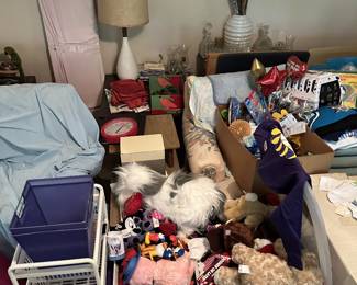 Bedroom storage with toys, plush animals, and household goods.