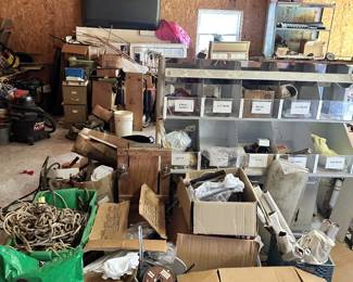 Workshop storage shelves, parts bins, boxes, and hardware.