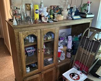 Glass display cabinet with collectibles and household decor.