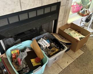 Fireplace area with storage bins, household items, and decor.