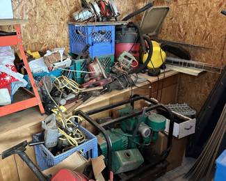 Green electric motor or pump, cords, and workshop equipment.