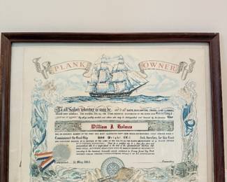 Framed nautical certificate and sailing-ship artwork.