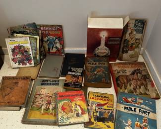 Vintage books, comic books, magazines, and illustrated collectible reading material.