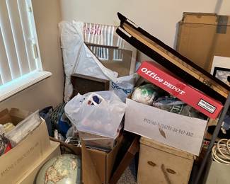 Packed household storage with lamps, boxes, and furniture.