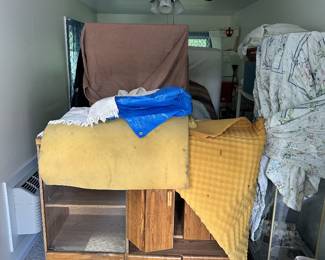 Stored furniture, textiles, boxes, and household items.