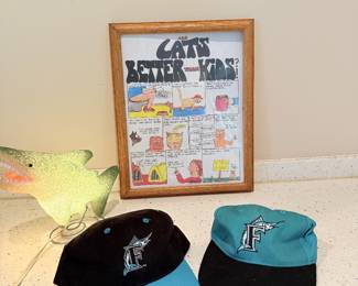 FSU hats, framed cat art, dinosaur lamp, and collectibles.