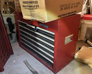 Red rolling mechanic's tool chest with drawers.
