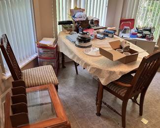 Dining table and chairs with household items.