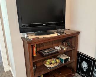 Flat-screen television and wooden media stand.