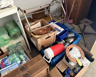 Utility cart, household storage boxes, chairs, and assorted supplies.