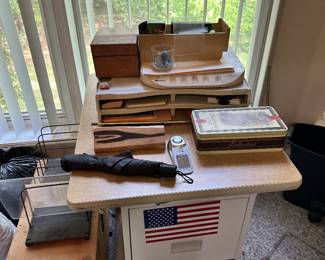 Wooden boxes, office equipment, small electronics, and storage.