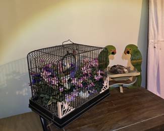 Decorative birdcage with artificial flowers.