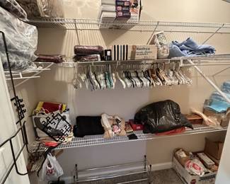 Clothing closet, shoes, signs, and household storage.