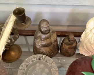 Buddha figurines, religious decor, and vases.
