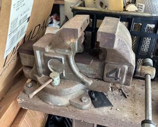 Heavy-duty metal bench vise.