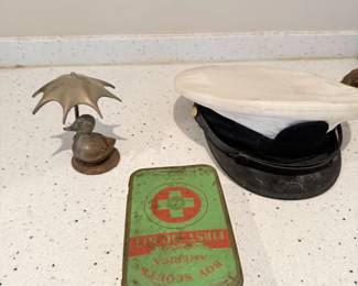 Vintage first-aid kit with sailor caps and military-style accessories.