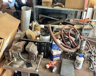 Hoses, clamps, fittings, bench vises, and hand tools.