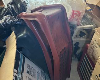 Red and black gasoline cans and automotive shop supplies.
