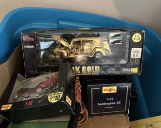 Boxed die-cast cars and collectible motorcycle models.