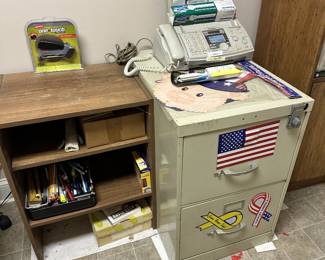 Office desk, filing cabinet, telephone, and electronics.