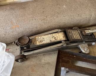 Automotive floor jack, vintage scales, gauges, and shop equipment.