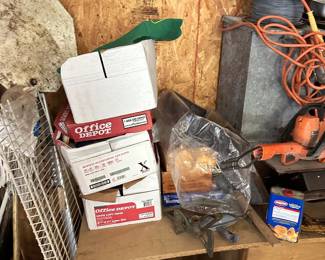Shop storage boxes, wire shelving, hand tools, and extension cords.