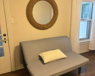 Futon and large round mirror