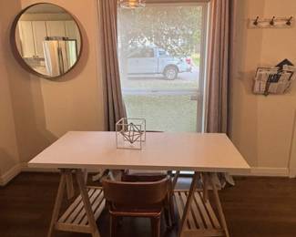 Large round mirror, White tabletop, with removable base, two copper and wood chairs.