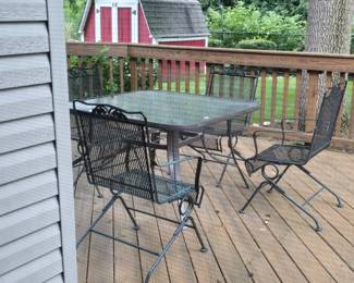 WROUGHT IRON ROCKING CHAIRS AND GLASS TABLE