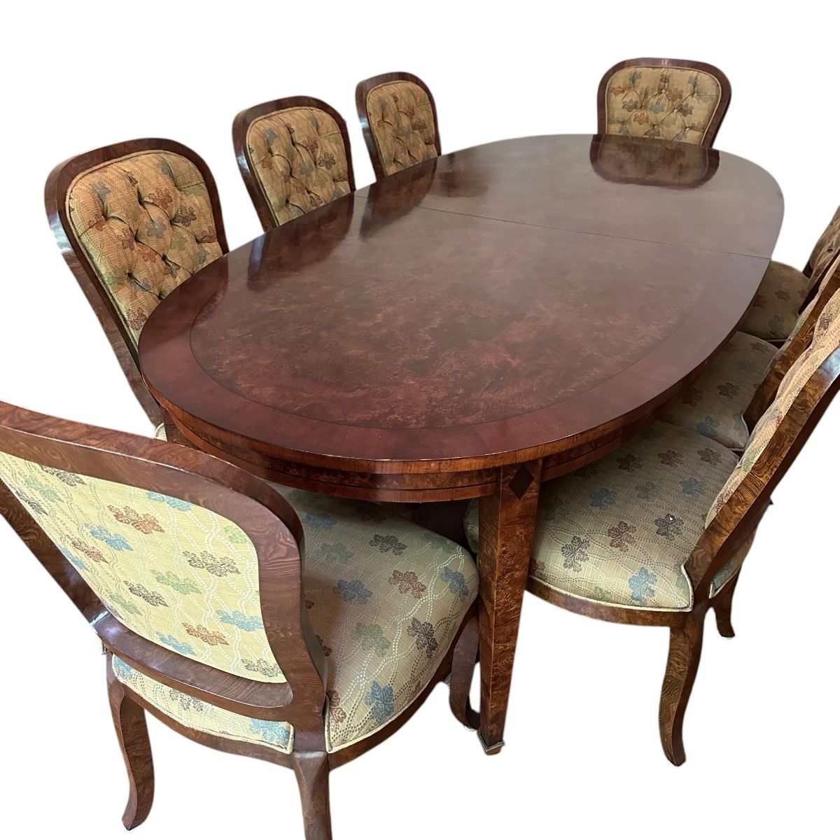 Switzer Oval Burled Poplar Dining Table with Cherry and Ebony Insets and Solid Brass Feet - seats 12 and includes two 20" extensions and custom table pads. 12 Rhulmann Side Dining Chairs in Olivewood Veneer with Tufted Backs