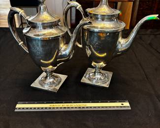 S39 - Sterling silver tea pots. (Left)$1,150. Smaller 798 grams.  Larger one (Right) $1400. 898 grams. Sterling silver tea pots. Monogrammed "EW". Smaller one has a broken lid.