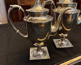 S39 - Sterling silver tea pots. (Left)$1,150. Smaller 798 grams.  Larger one (Right) $1400. 898 grams. Sterling silver tea pots. Monogrammed "EW". Smaller one has a broken lid.