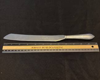 S37 - $50. Serrated knife, Sterling handle. Made in Sheffield, England  