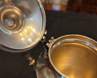 S39 - Sterling silver tea pots. (Left)$1,150. Smaller 798 grams.  Larger one (Right) $1400. 898 grams. Sterling silver tea pots. Monogrammed "EW". Smaller one has a broken lid.