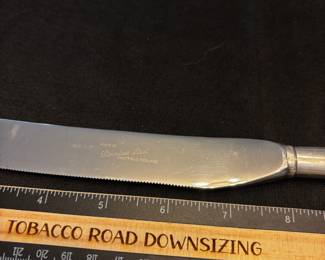 S37 - $50. Serrated knife, Sterling handle. Made in Sheffield, England  