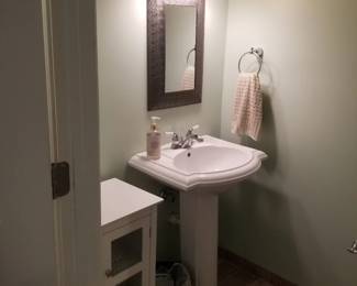 Pedestal sink; mirror; vanity lights; storage cabinet