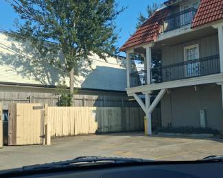You will have to follow the parking lot on the left to the back of the building in order to enter the back of Apt. 6. 