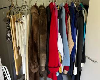A selection of table linens, furs, and jackets