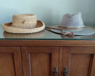 Straw hats on cabinet top