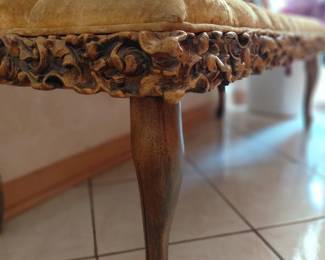 Carved wood footstool with upholstered top