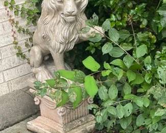Cast stone lion garden statue in ivy